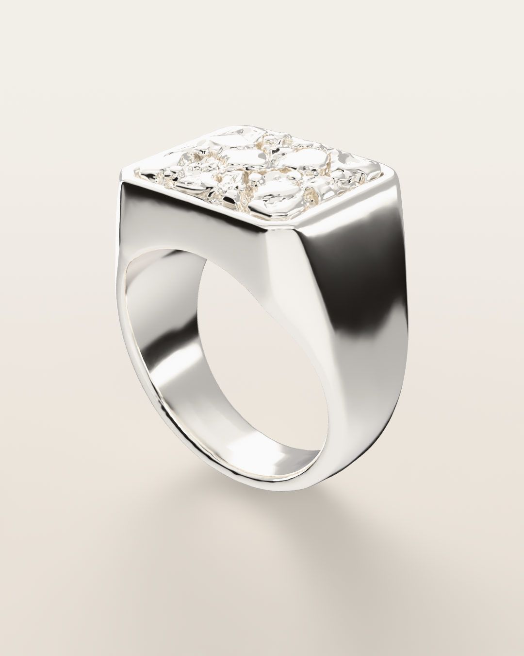 No. 501 Anvil nugget ring, turning slowly under a low light, sterling silver, rendered from the production 3D file