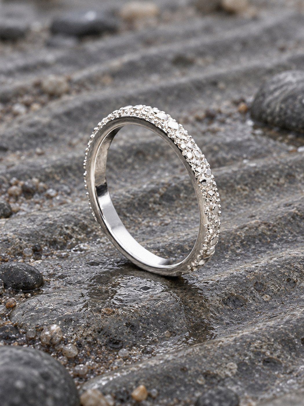 Ripple No. 106 in sterling silver, still life on river stones