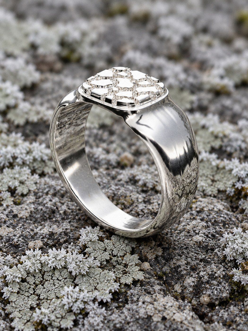 Pinky No. 405 in sterling silver, still life on weathered stone and wood