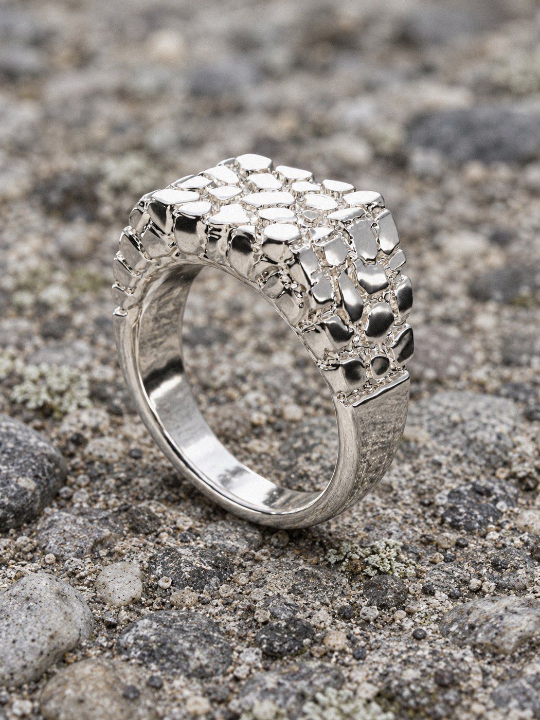 Wide Face No. 406 in sterling silver, still life on weathered stone and wood