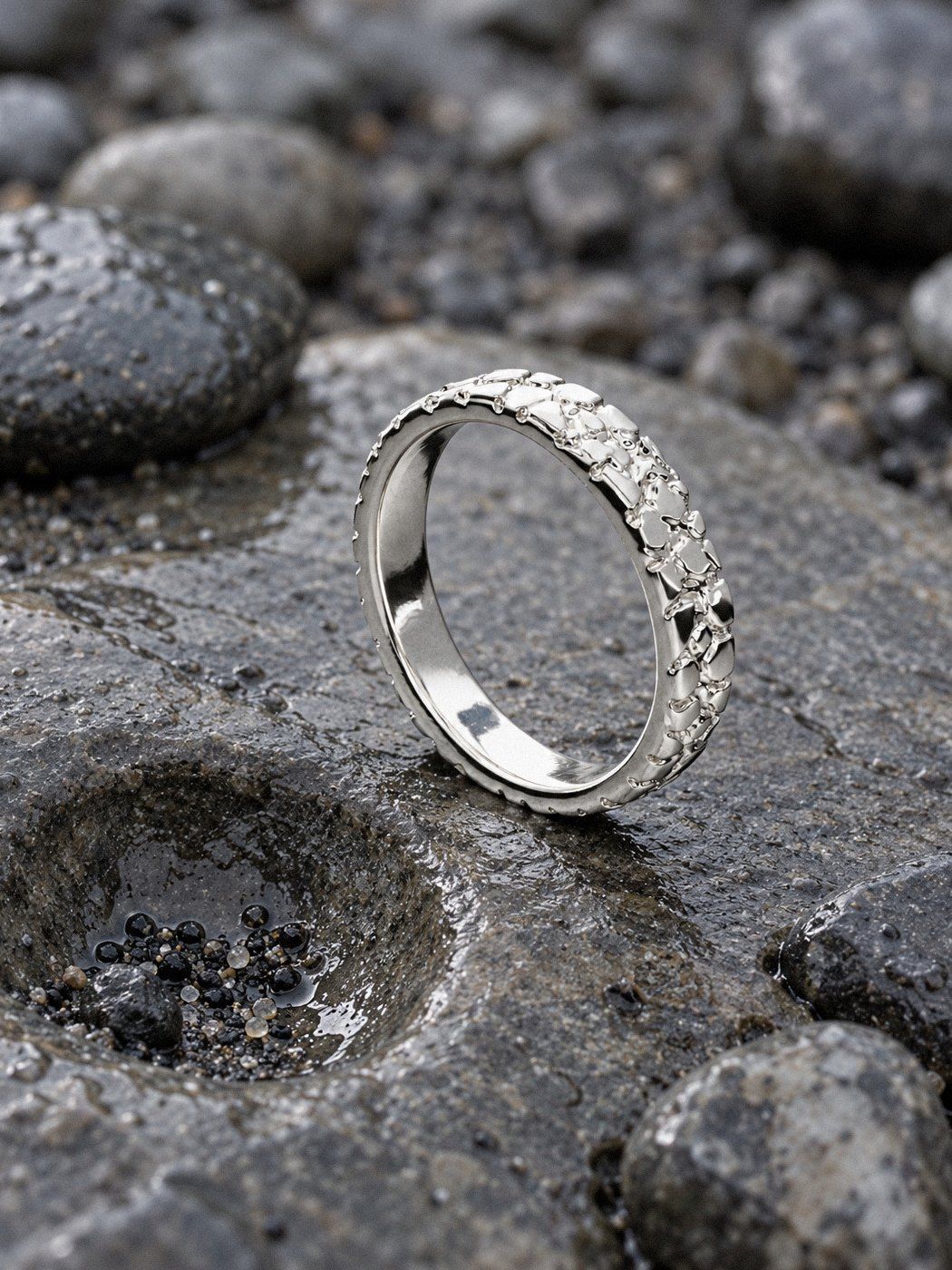 Stack Band No. 407 in sterling silver, still life on river stones