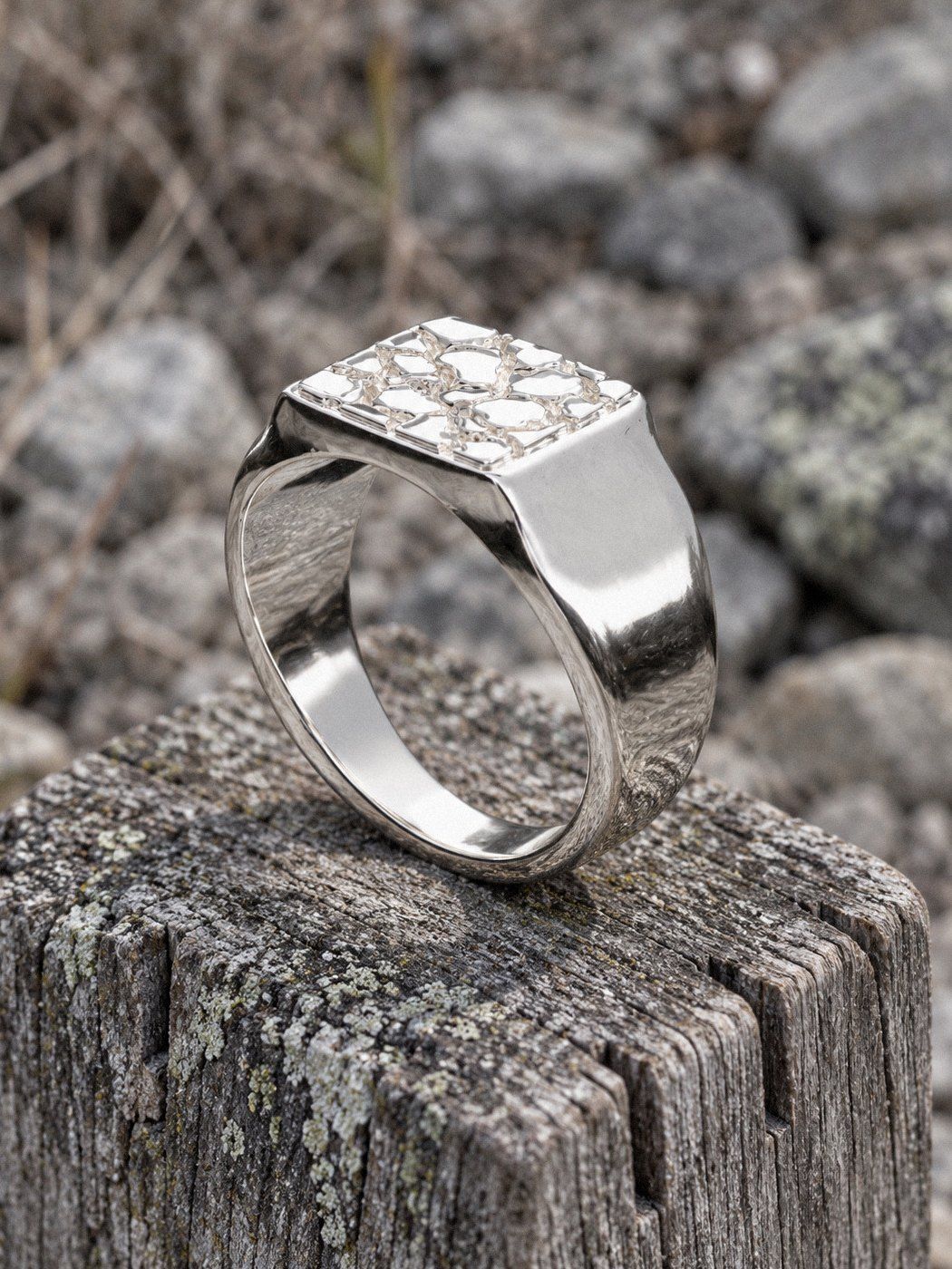 Signet M No. 409 in sterling silver, still life on weathered stone and wood