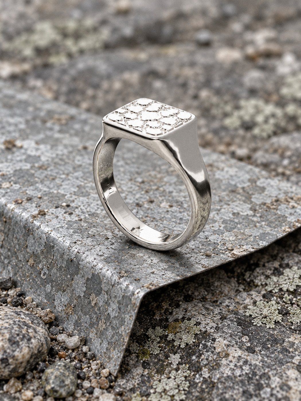 Signet M No. 431 in sterling silver, still life on weathered stone and wood