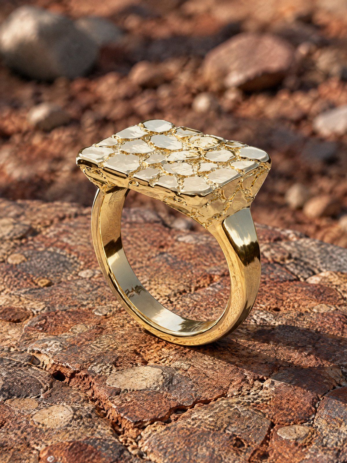 Wide Face No. 433 in solid 14K gold, still life on weathered stone and wood